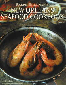Book Cover says "Ralph Brennan's New Orleans Seafood Cookbook" in white over photo of delicious gulf shrimp cooking in a pot.