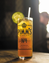 Load image into Gallery viewer, Pimm&#39;s Cup shown on table full of famous Pimm&#39;s cocktail and a cucumber slice. 